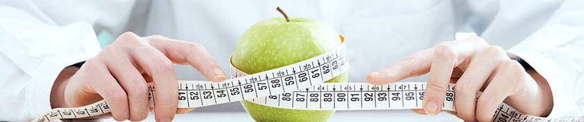 Girl measures apple with a centimeter ribbon